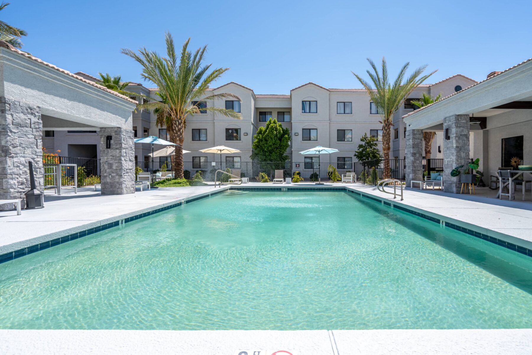 Pool with deck seating and covered grill pavilion