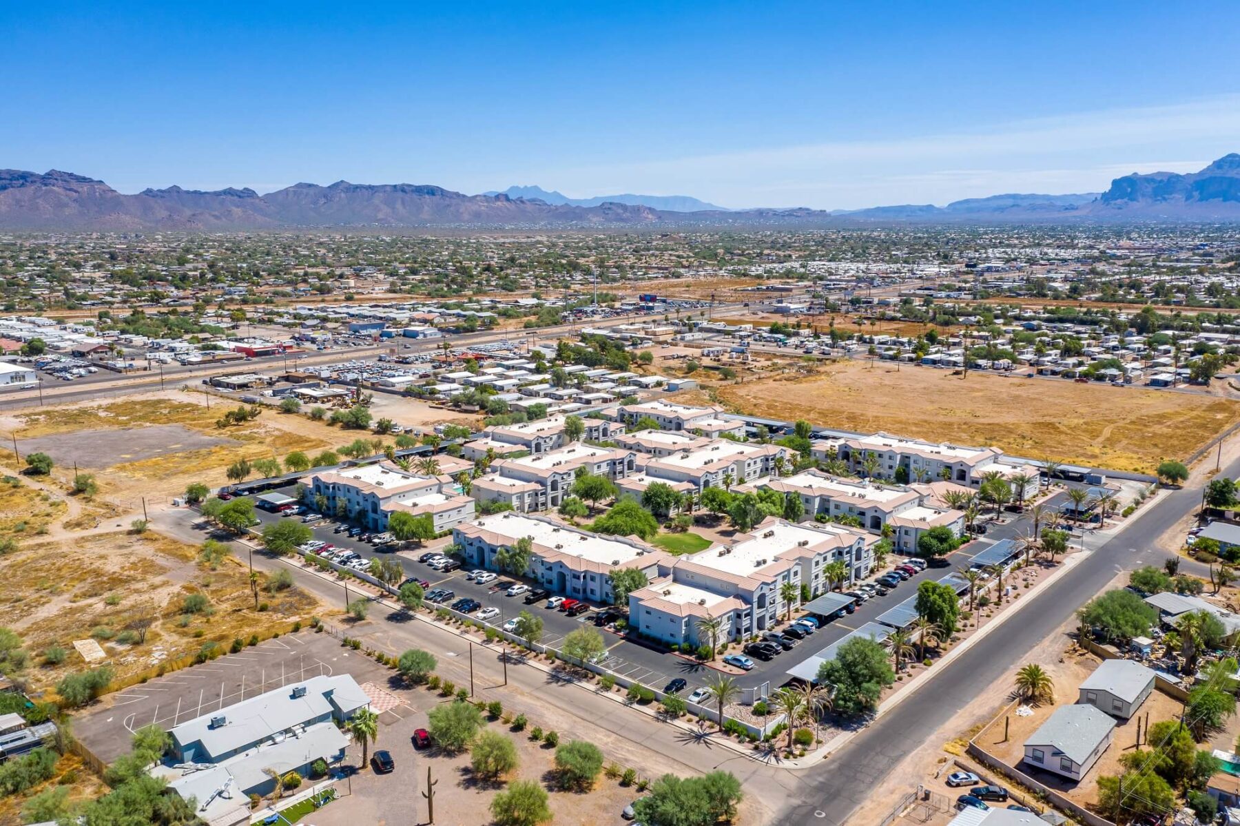Aerial view of community, showing surrounding suburbs and mountains in the far distance